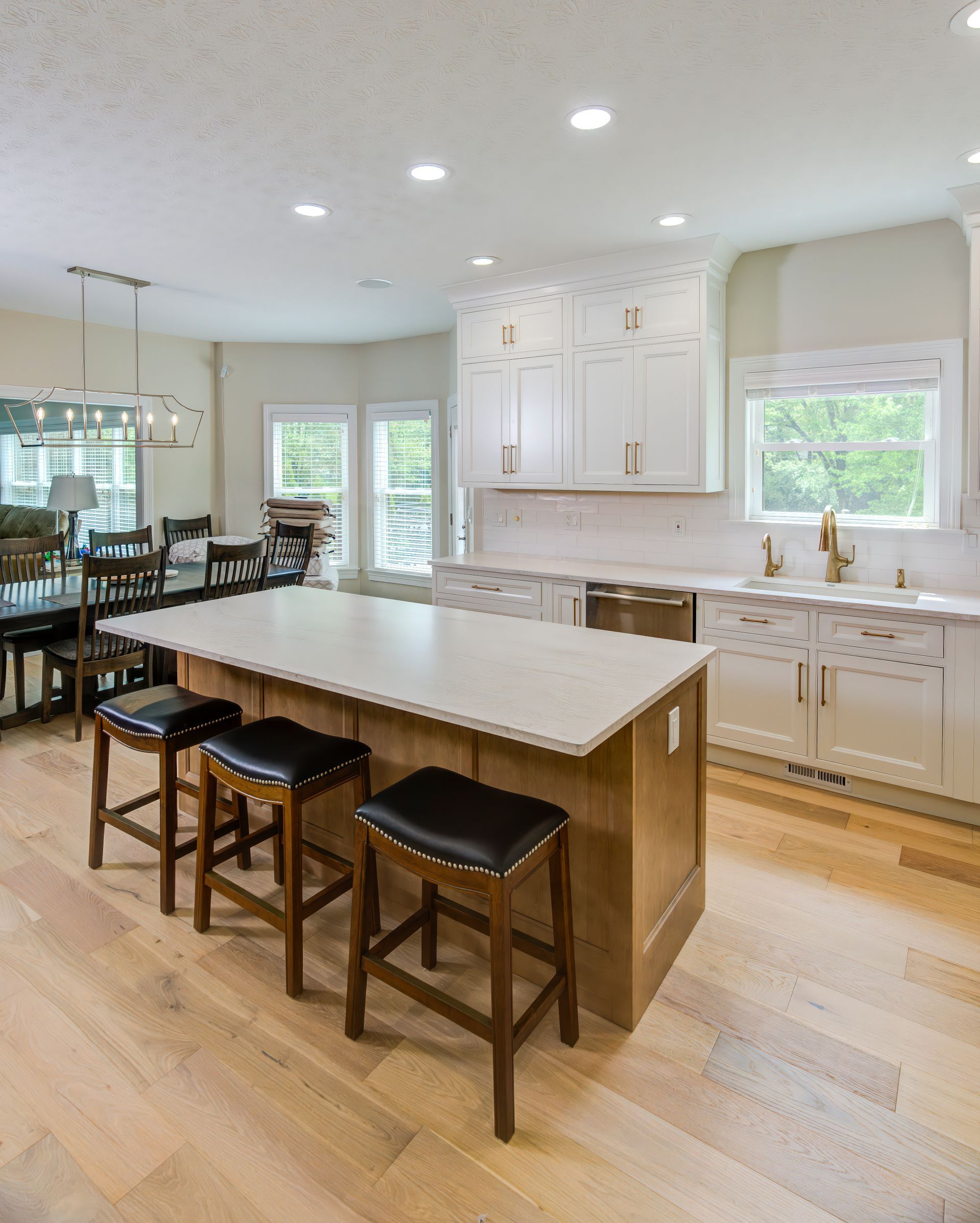 A kitchen with a large island and stools