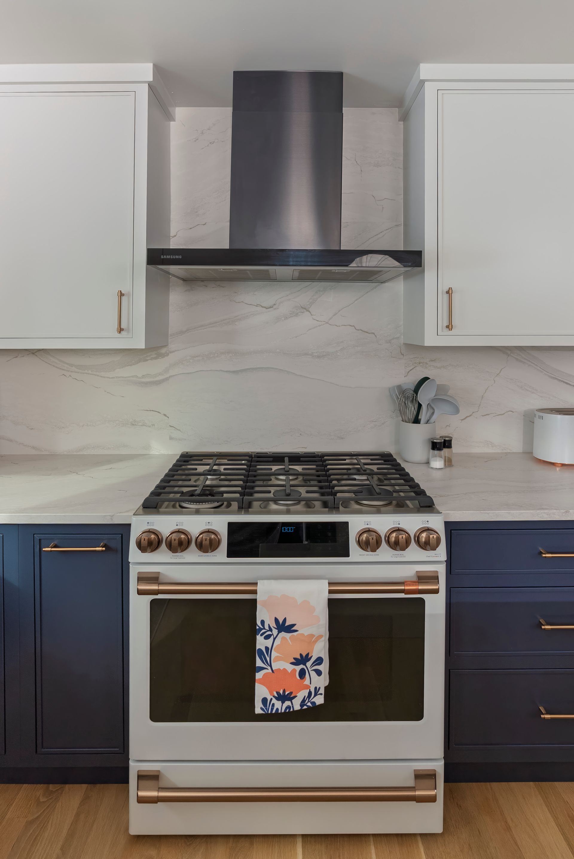 A kitchen with blue cabinets and a white stove top oven.