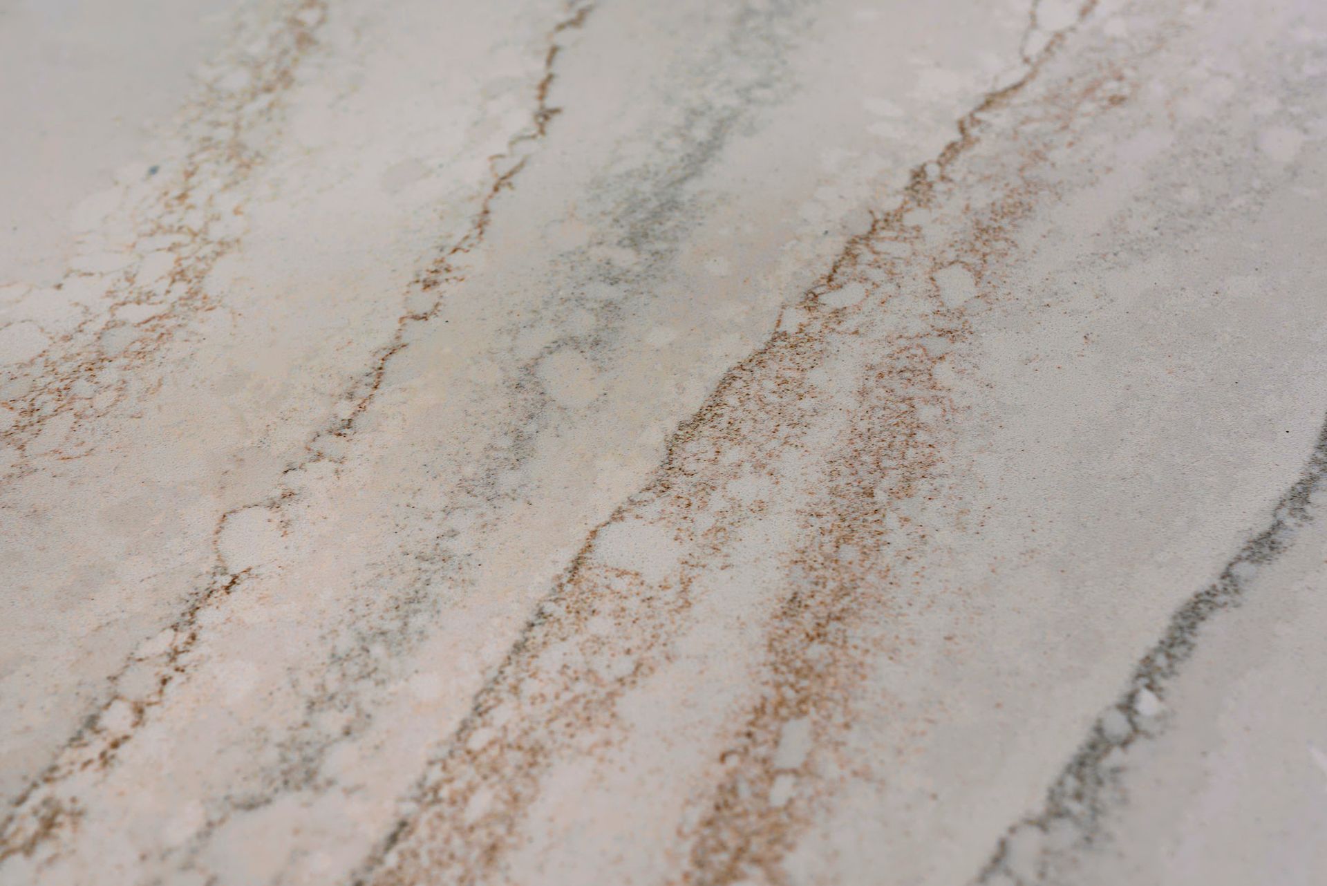 A close up of a white and brown marble counter top.