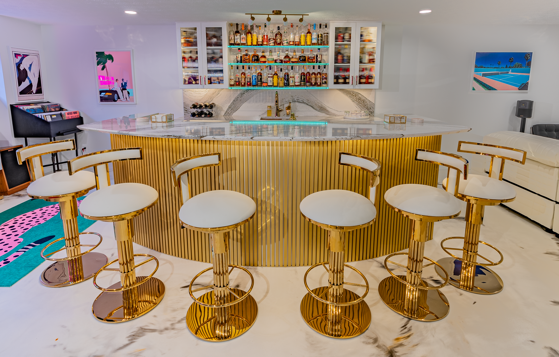 A bar with gold stools and a marble floor.