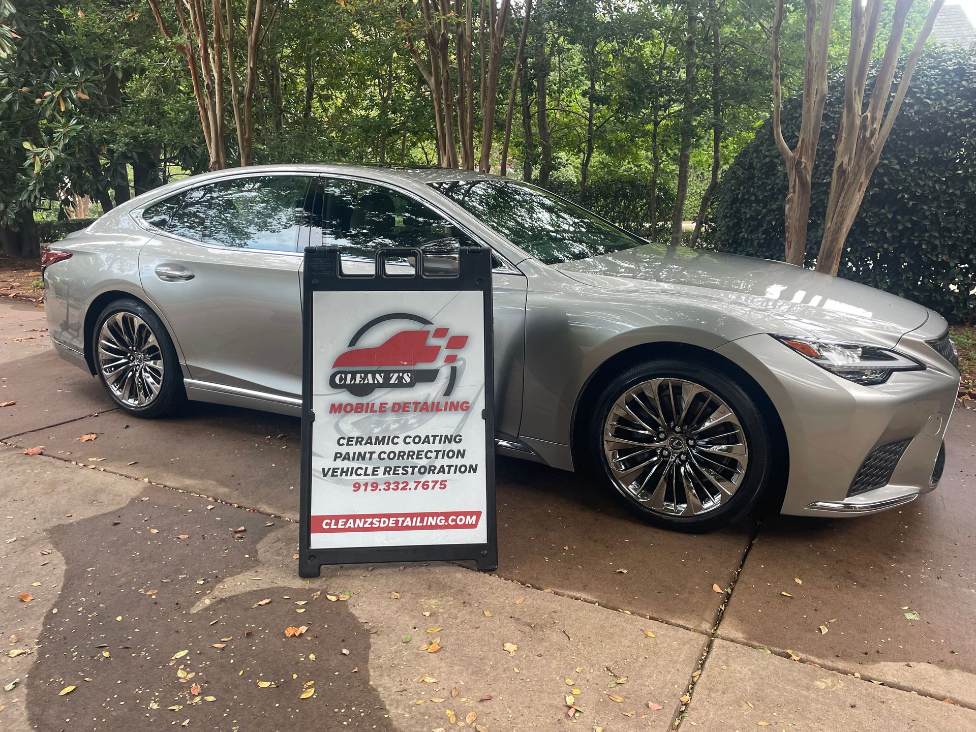 White Range Rover SUV parked on a driveway in a residential neighborhood.