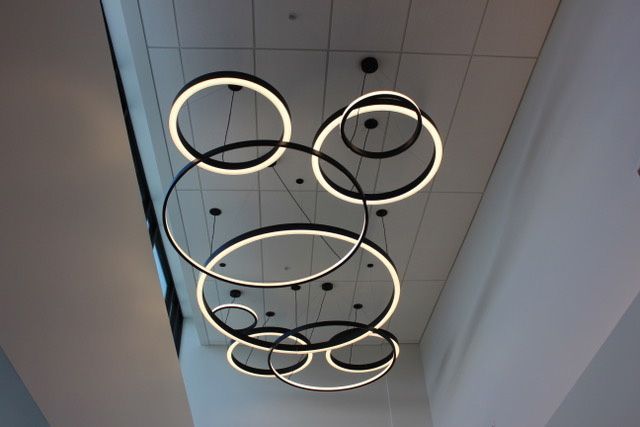 A bunch of circles are hanging from the ceiling