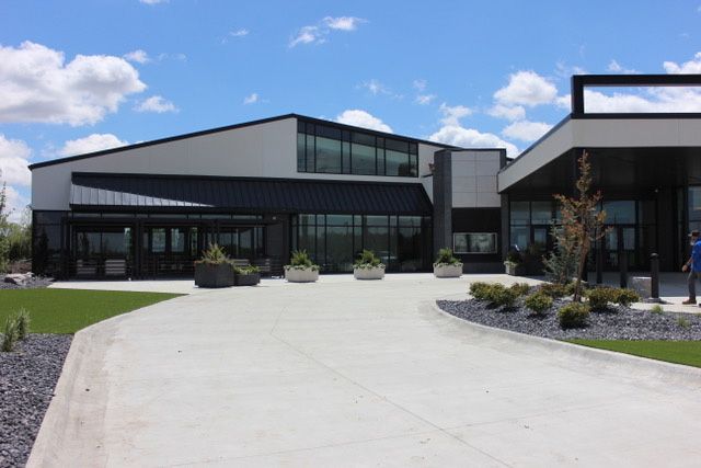 A large building with a concrete driveway leading to it
