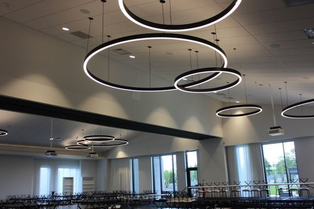 A large room with a lot of lights hanging from the ceiling.