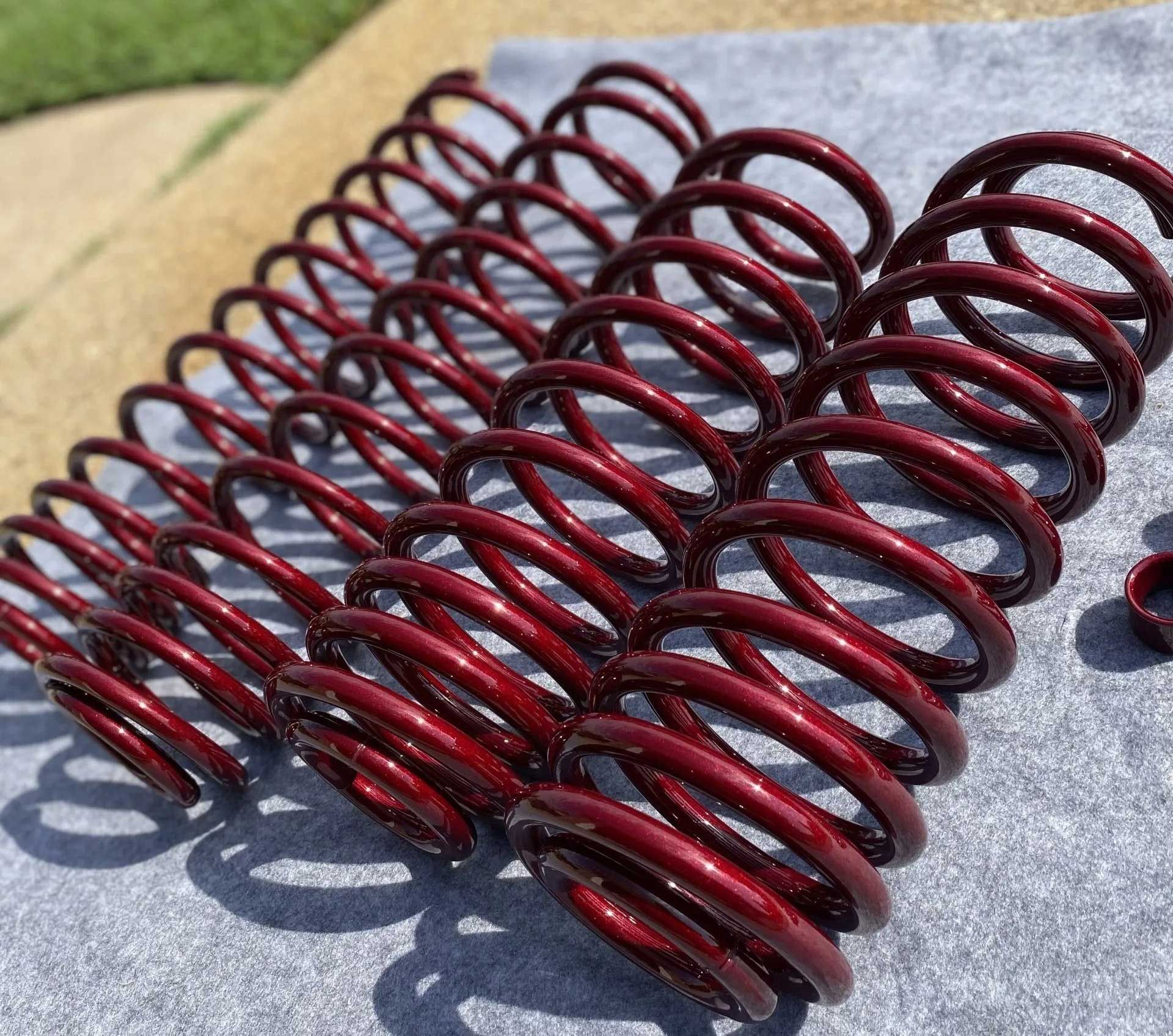Red coil springs arranged in rows.