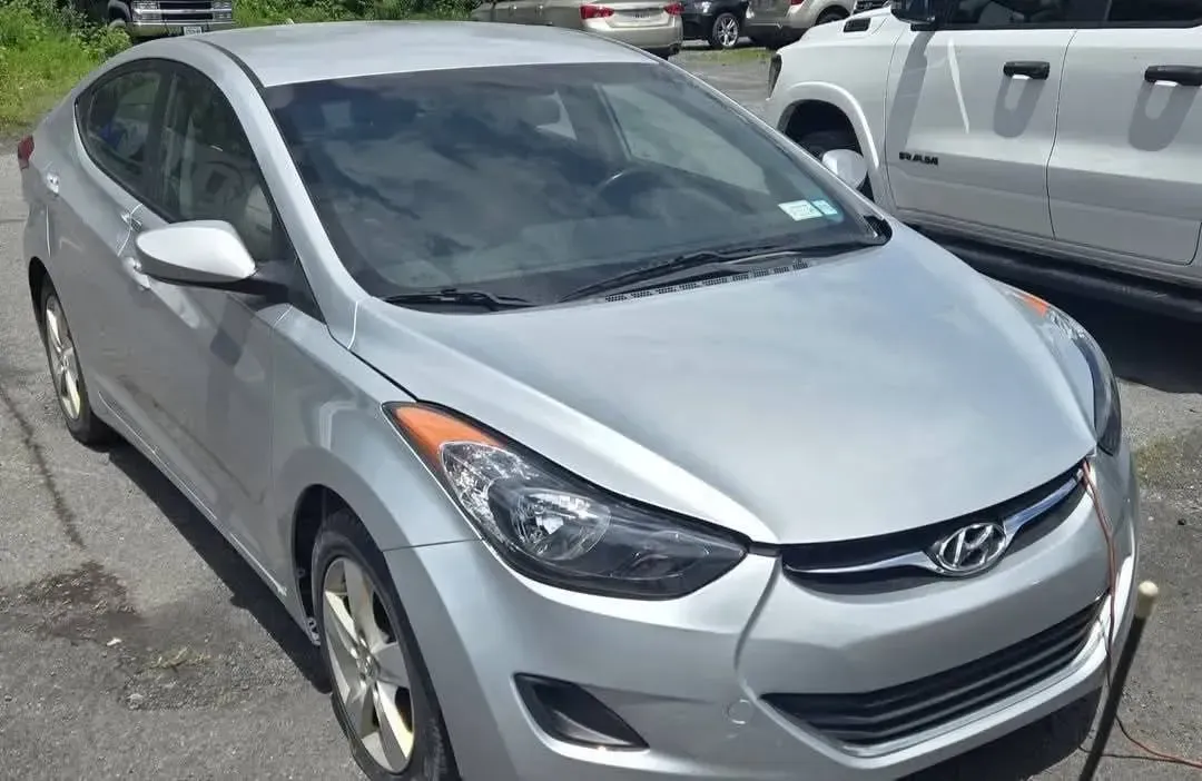 Silver Hyundai Elantra sedan parked outdoors on a paved lot.