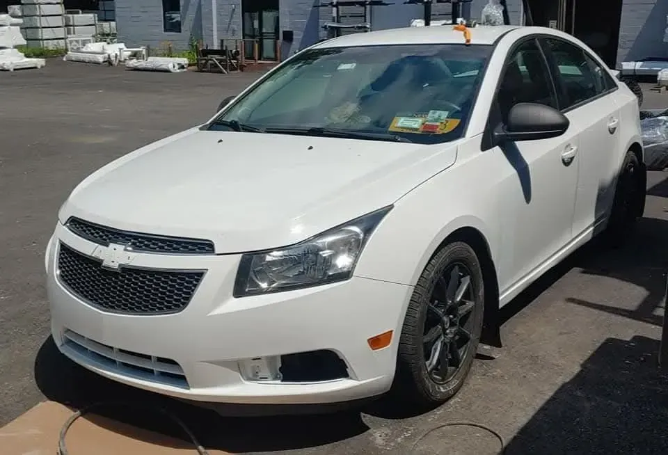White Chevrolet Cruze car parked outdoors.
