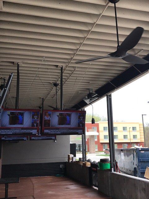 A ceiling fan is hanging from the ceiling of a building