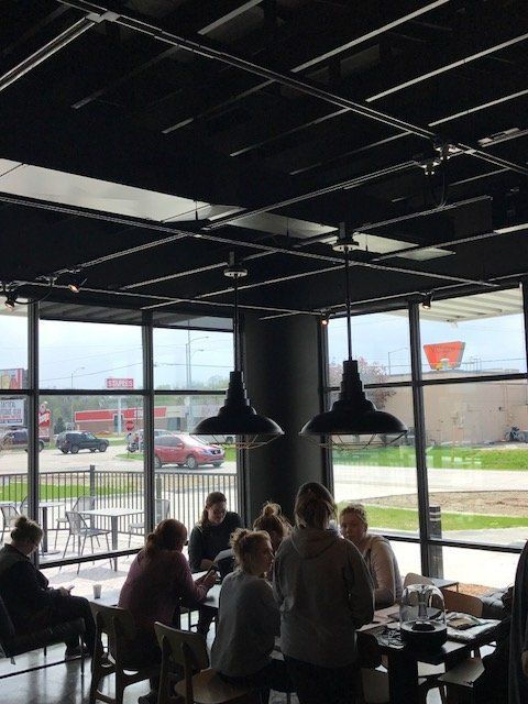 A group of people are sitting at tables in a restaurant