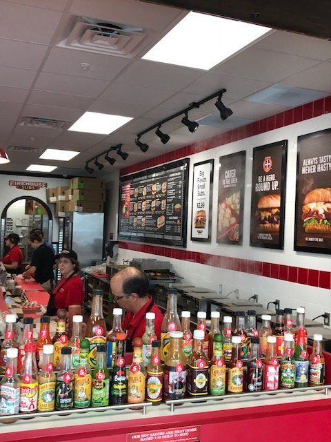 A restaurant with a lot of bottles and cans on the counter