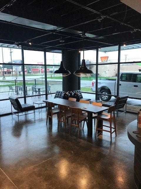 A large room with a table and chairs in it