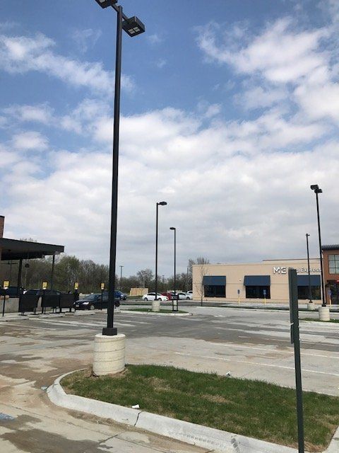 A parking lot with a building in the background