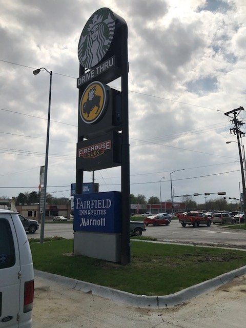 A white van is parked in front of a starbucks drive thru