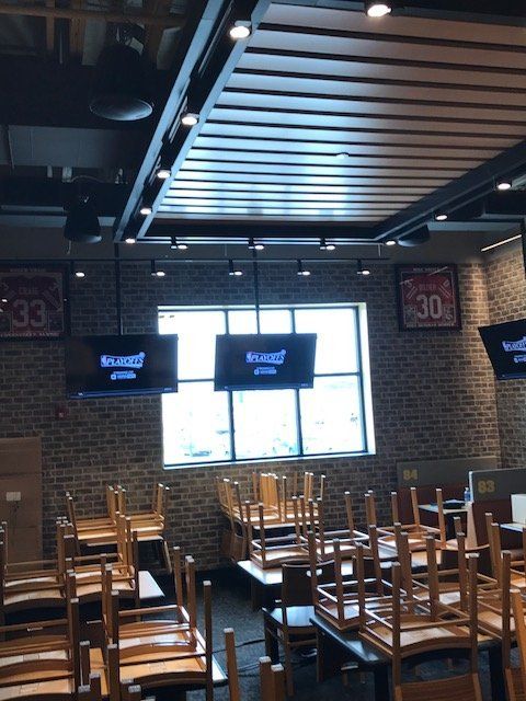 Empty tables and chairs in a restaurant with a sign that says 30