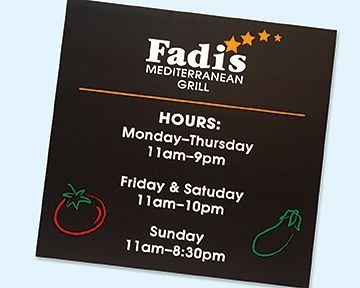 Sign for Fadis Mediterranean Grill showing hours: Mon-Thurs 11am-9pm, Fri & Sat 11am-10pm, Sun 11am-8:30pm.