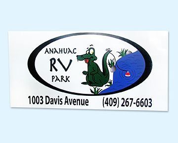 Sign for Anahuac RV Park, with a cartoon alligator fishing near water. Includes address and phone number.