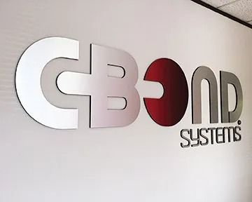 CBOND SYSTEMS logo on a white wall; large silver letters with a red accent, and small 