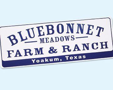 Sign for Bluebonnet Meadows Farm & Ranch in Yoakum, Texas, blue and white text.