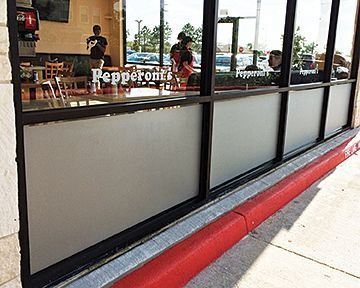 Exterior of Pepperoni's restaurant with frosted lower window panes; people visible inside near tables.
