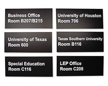 Six black rectangular office signs with white text indicating office names and room numbers.