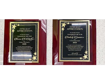 Two awards on red plaques, one for Thresa Elle Dooling, the other for Kimberly Gummerson, both for 