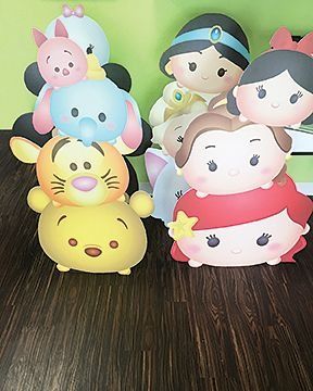 Tsum Tsum character cutouts stacked, including Winnie the Pooh, princesses, and Minnie Mouse.