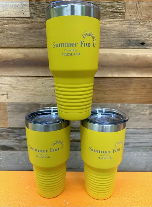 Three yellow insulated tumblers stacked, the center one balanced on the other two. Each has a lid and 