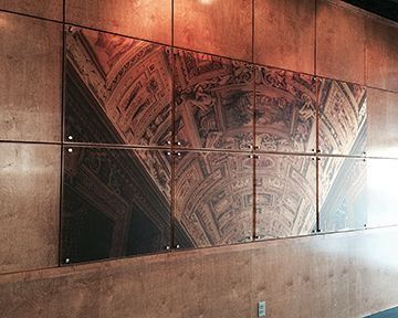Six panels of a detailed architectural ceiling print on a brown wall.