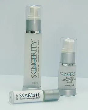 Three skincare product bottles, white with silver caps; one lying down, two standing.