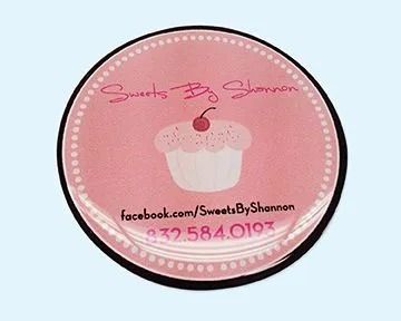 Logo for Sweets By Shannon: pink cupcake, text, and contact information on a round, pink background.