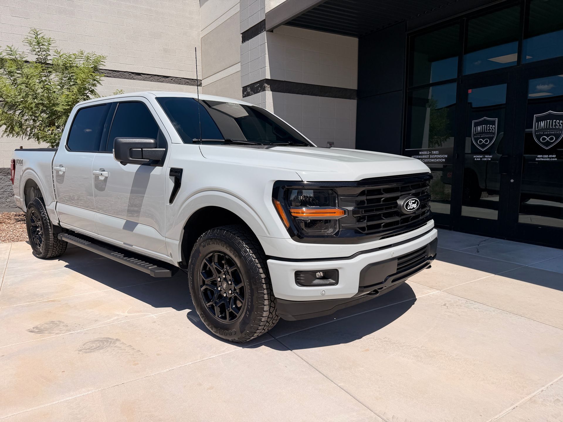 White Ford pickup truck parked outside a building in daylight
