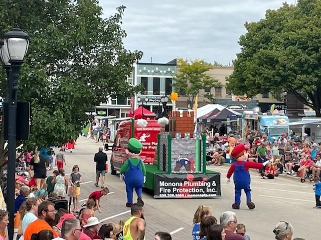 A parade with mario and luigi on a float