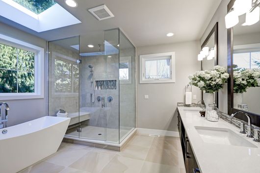 A bathroom with two sinks and a large mirror.