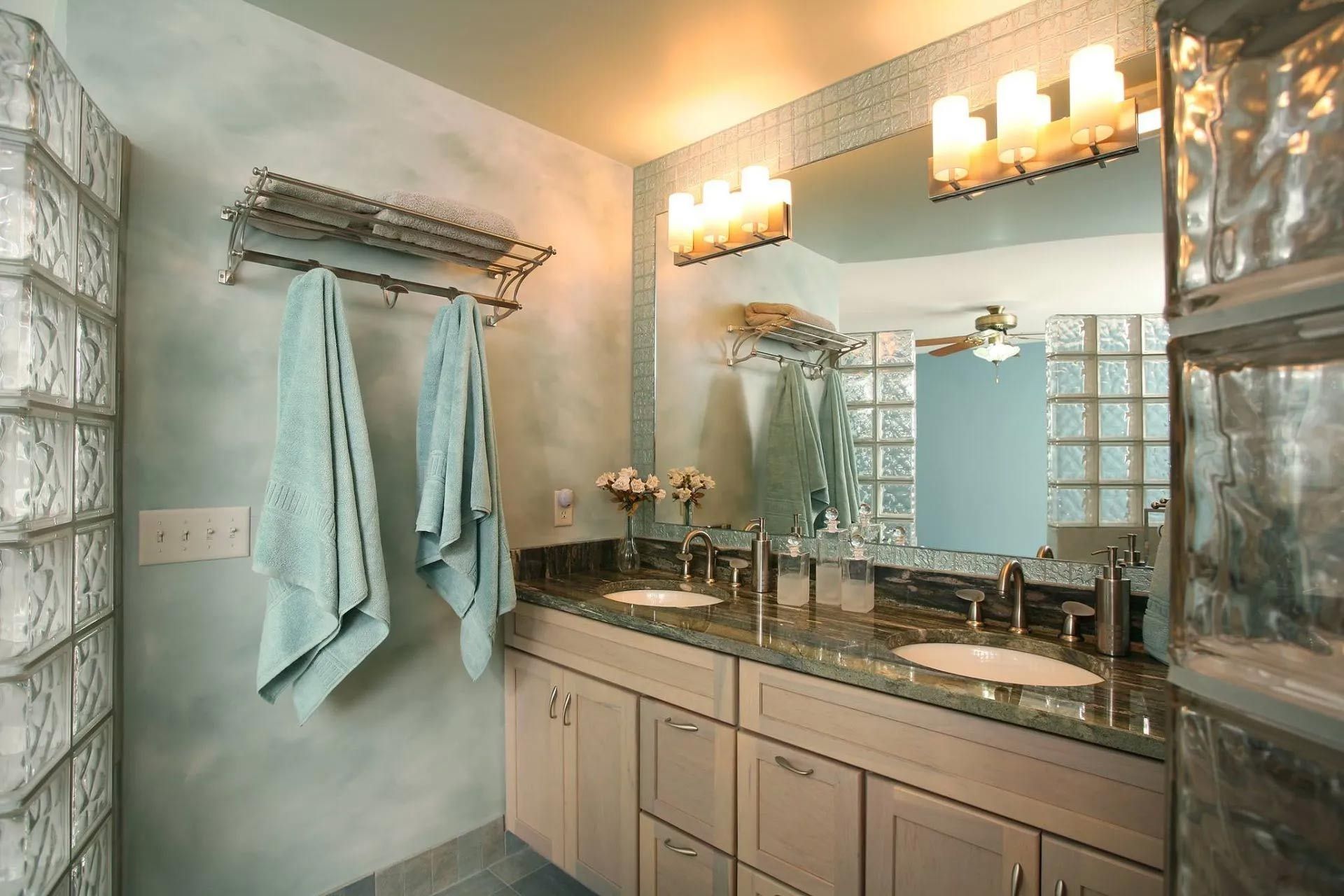 A bathroom with two sinks and a large mirror