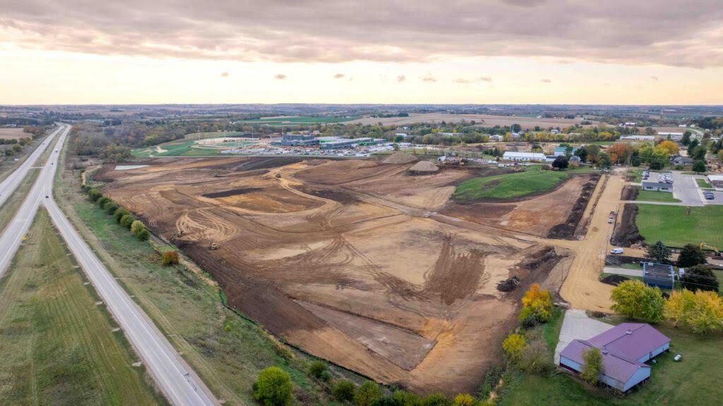 Aerial view of a large construction site with graded earth