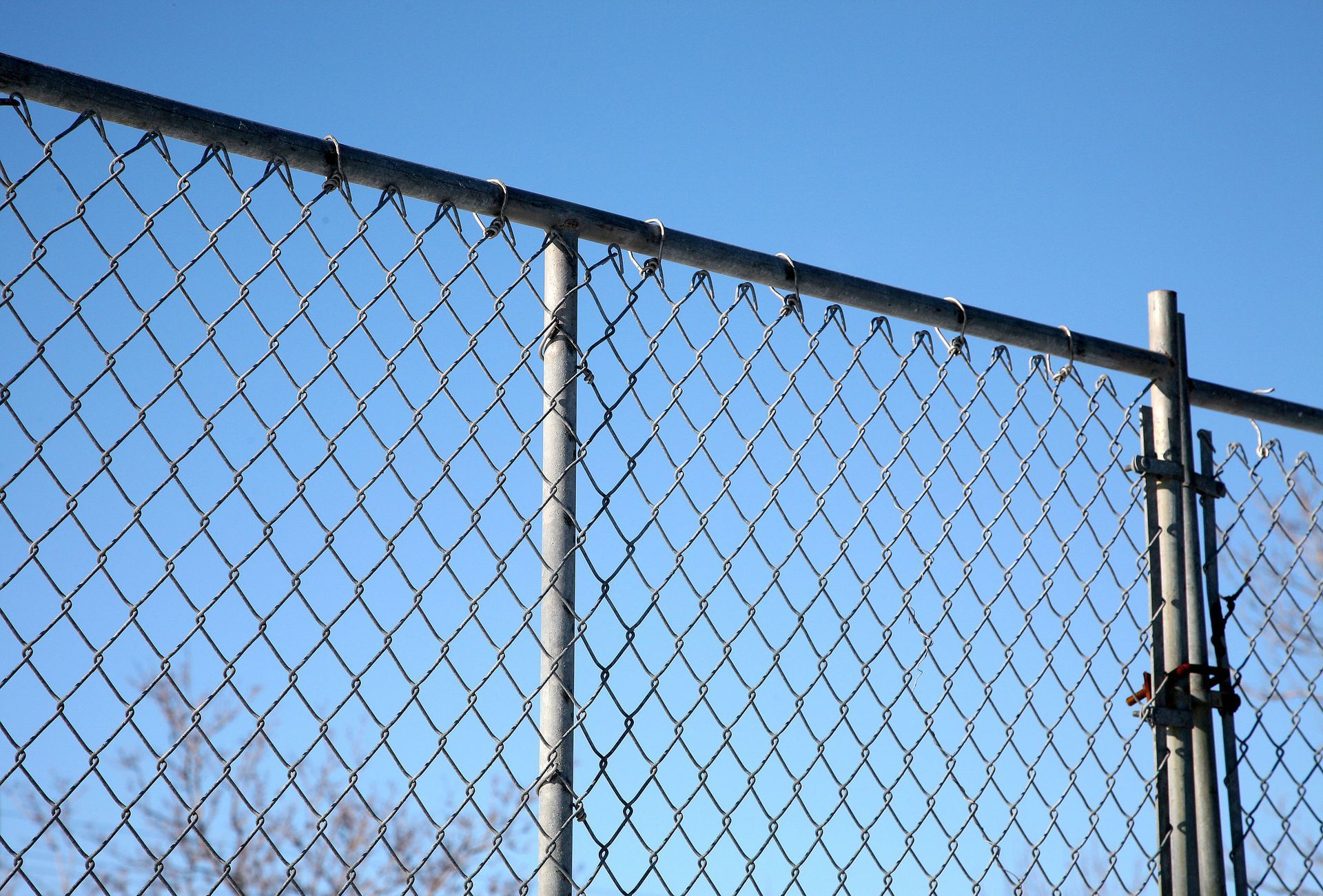 Chain-link fence against a blue sky
