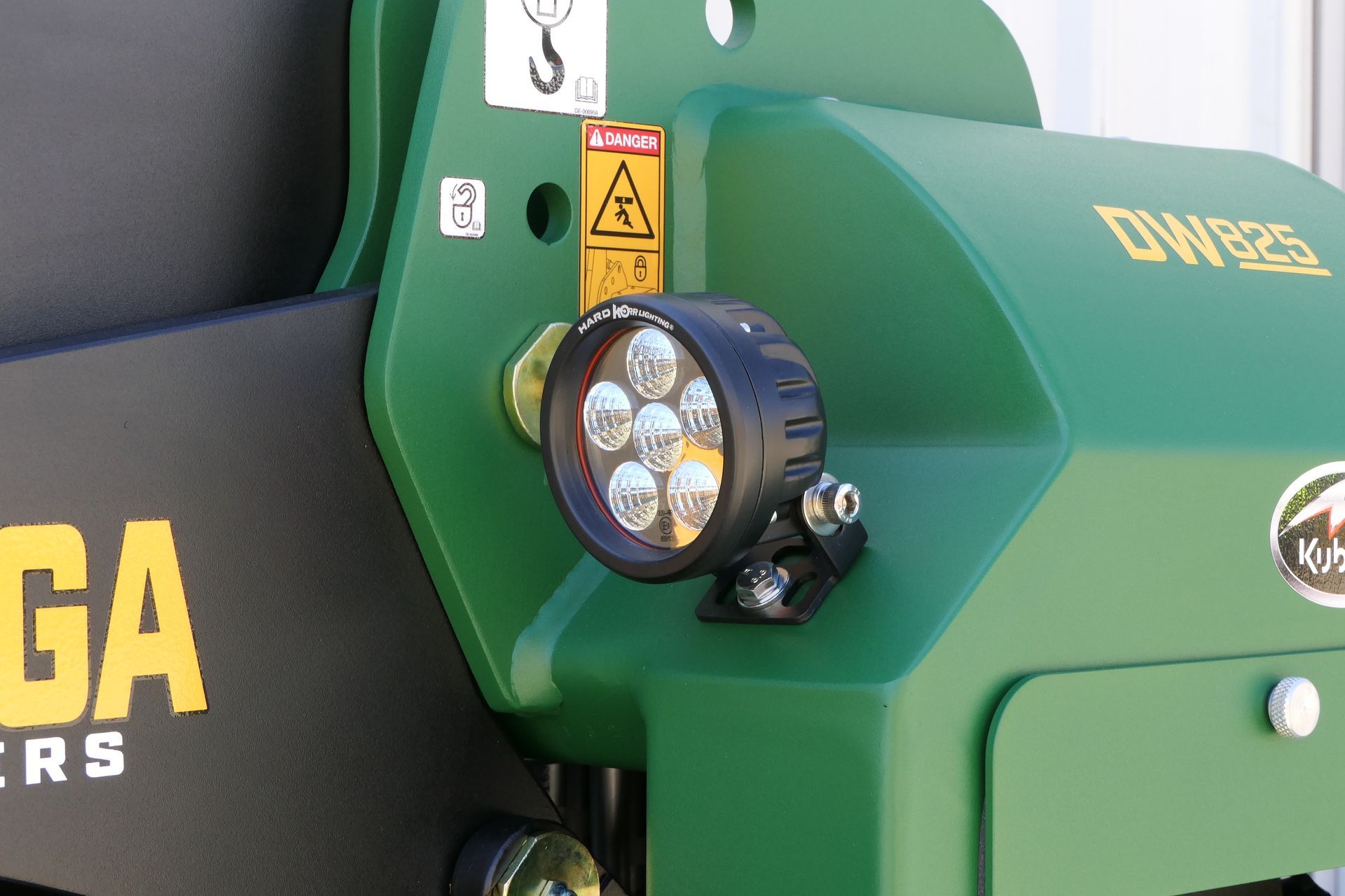 A green and black tractor with the word Kanga on the side