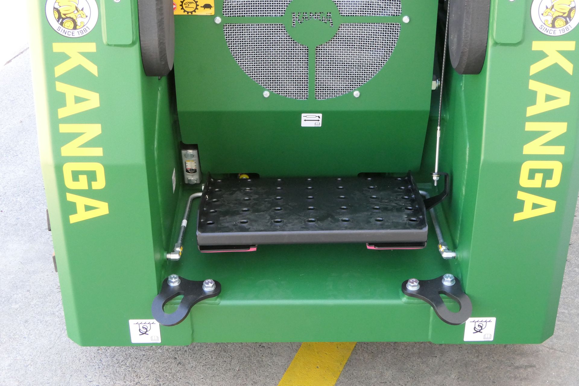 A green Kanga is parked in a parking lot