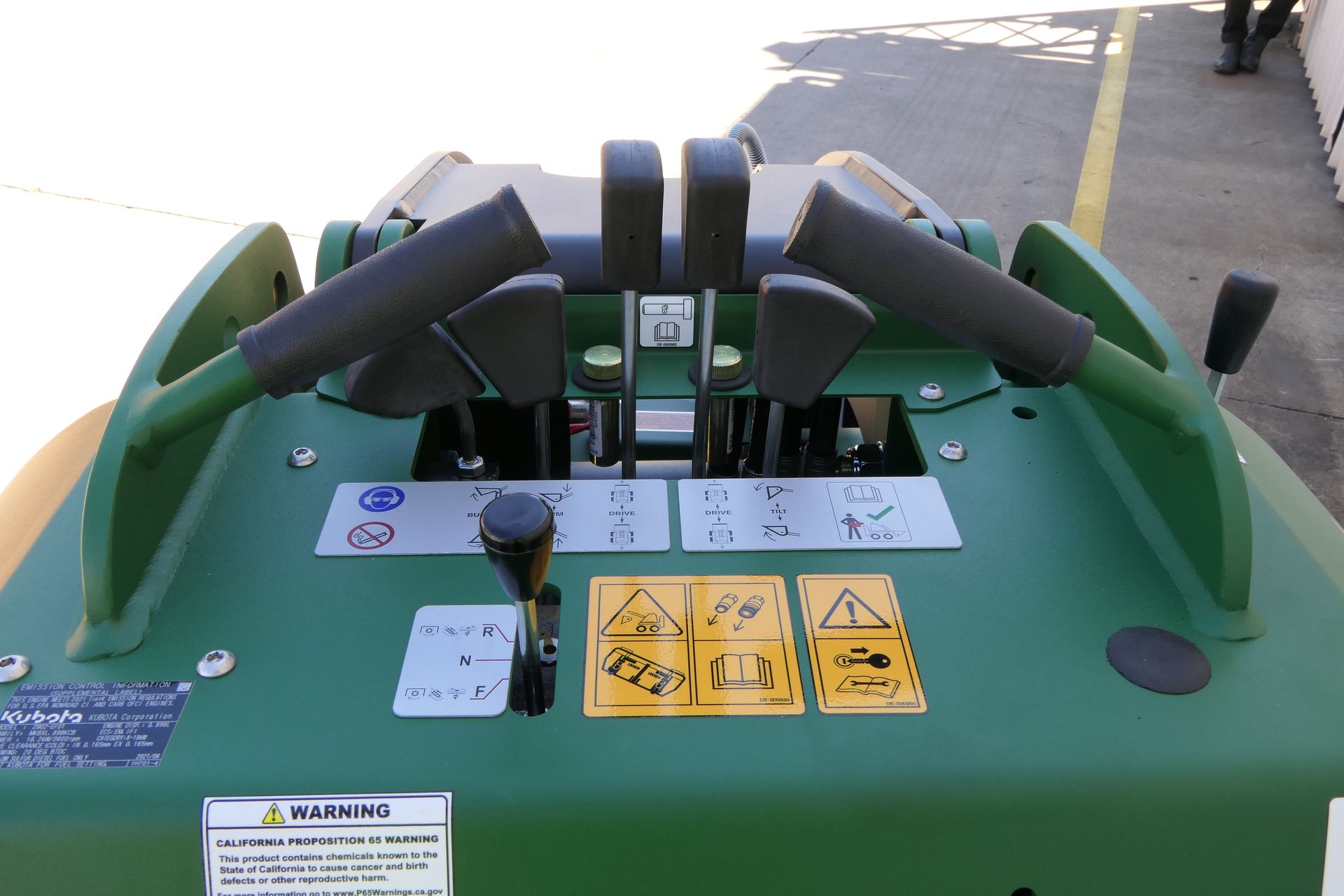 A green Kanga tractor is parked in a parking lot