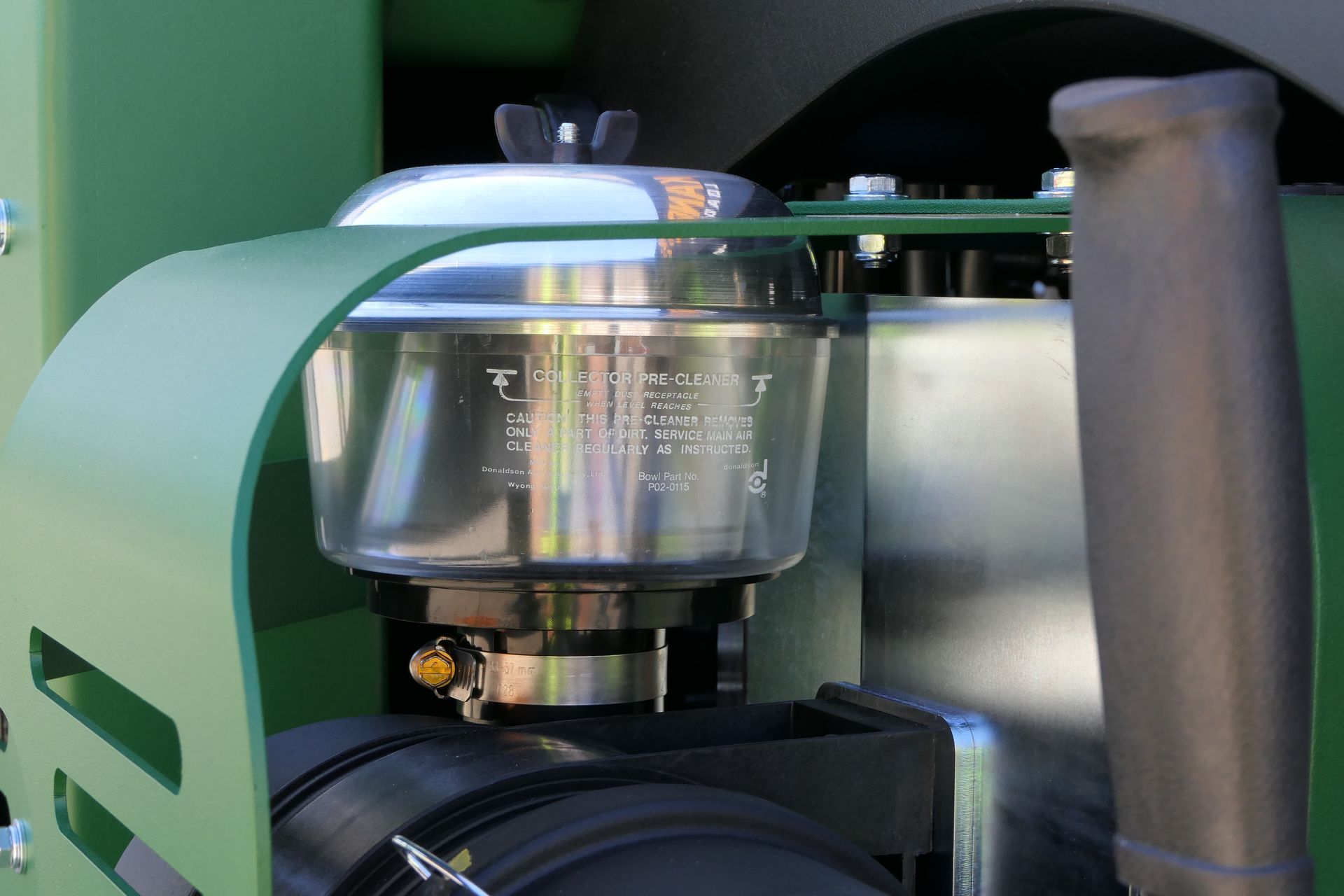 A green tractor with a clear air filter attached to it