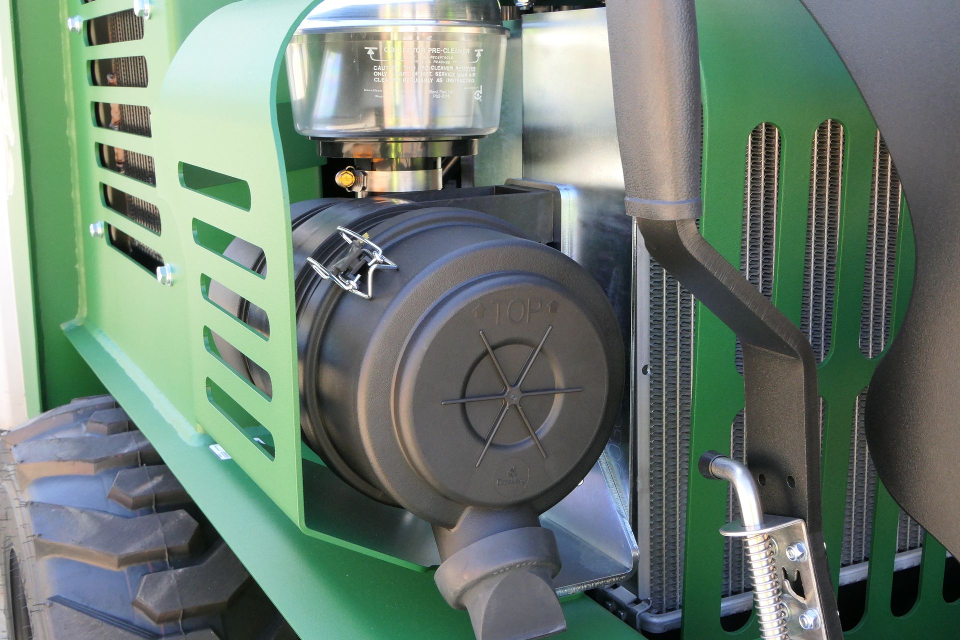 A close up of a green machine with a filter on it