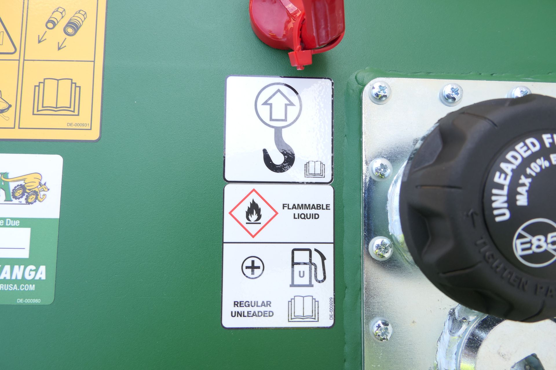 A close up of a fuel cap that says unleaded