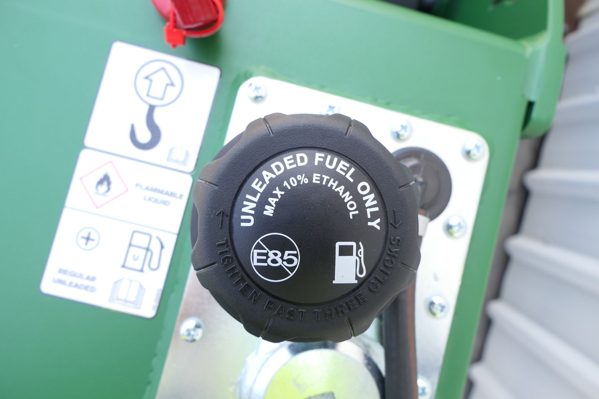 A close up of a fuel cap that says unleaded fuel only