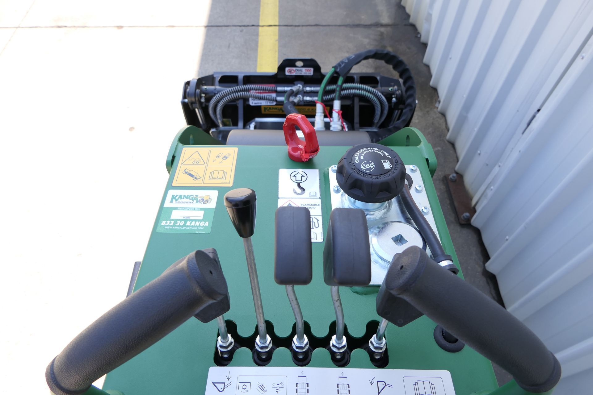 A green Kanga vehicle with a steering wheel and controls