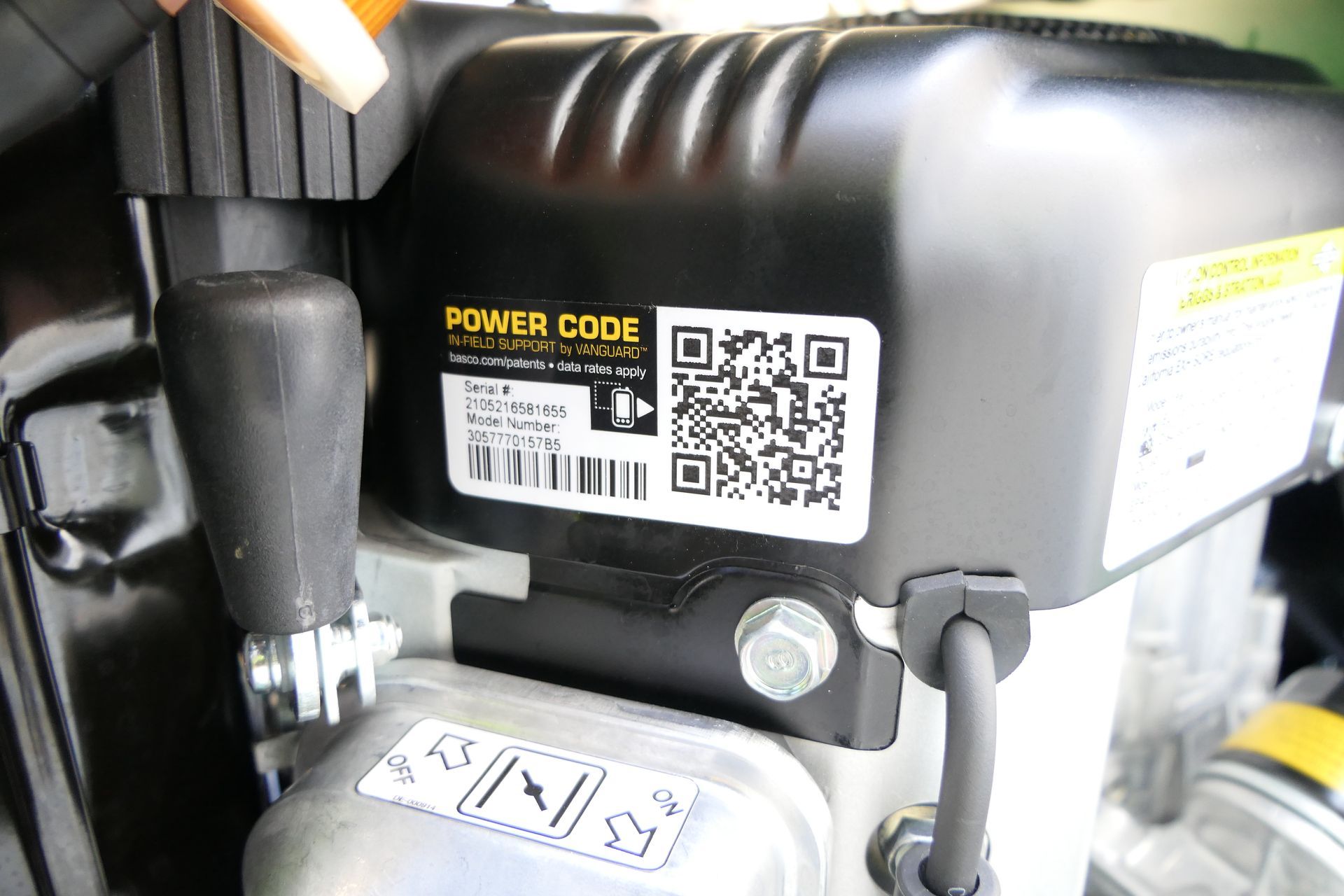 A close up of a power code sticker on a engine