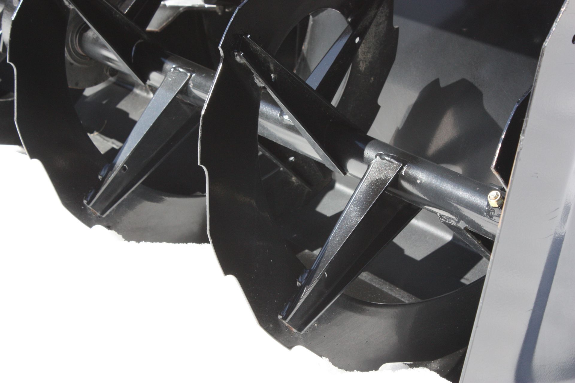 A close up of a snow blower on a white background.