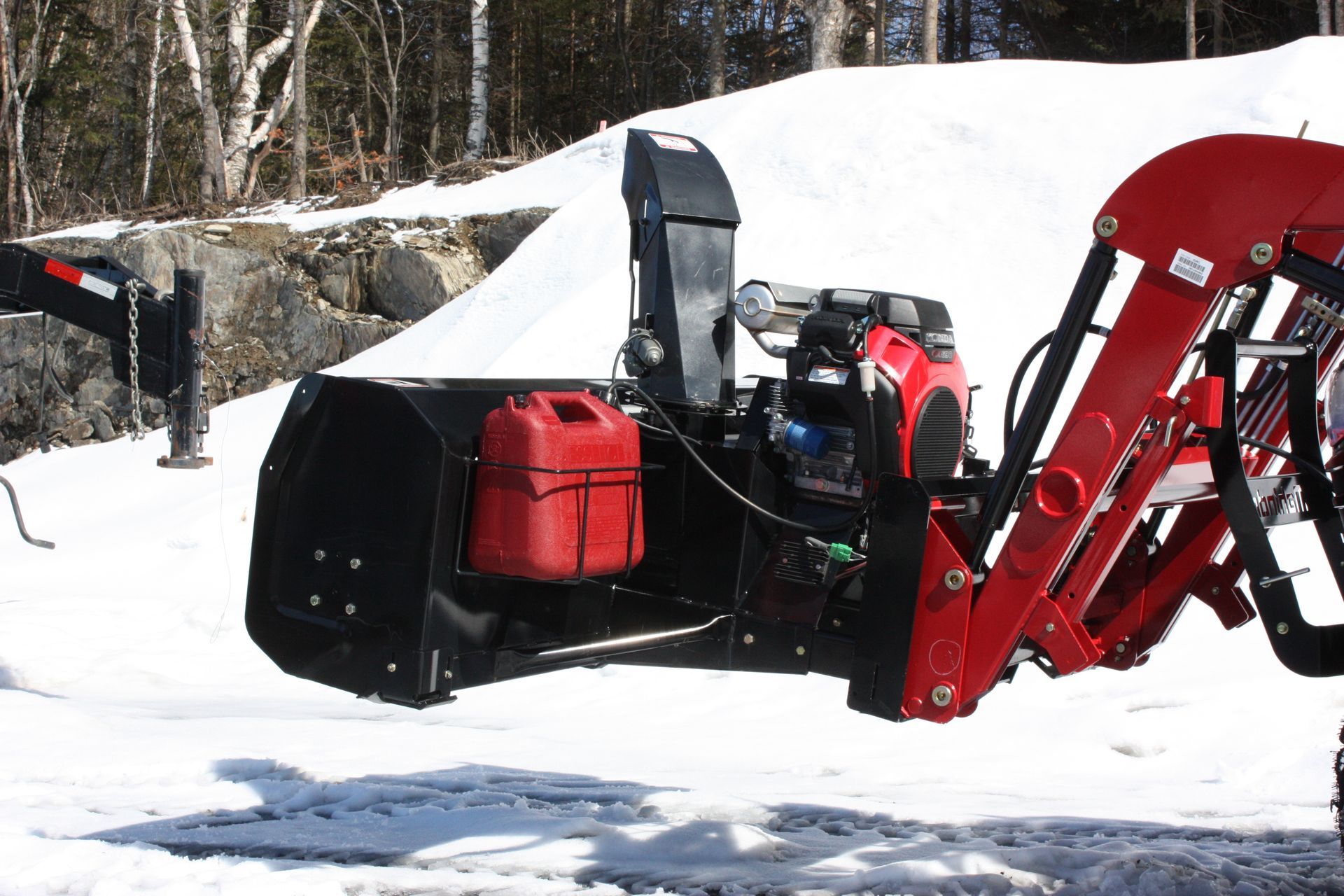 A red and black snow blower 54