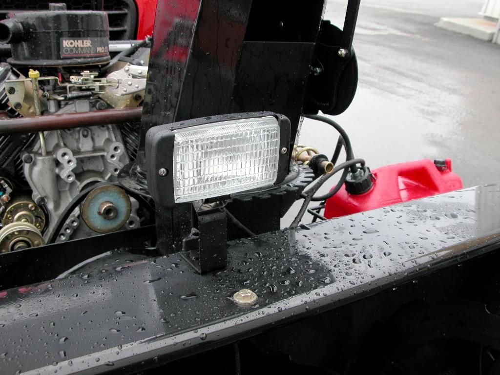 A light is mounted to the side of a snow plow 54