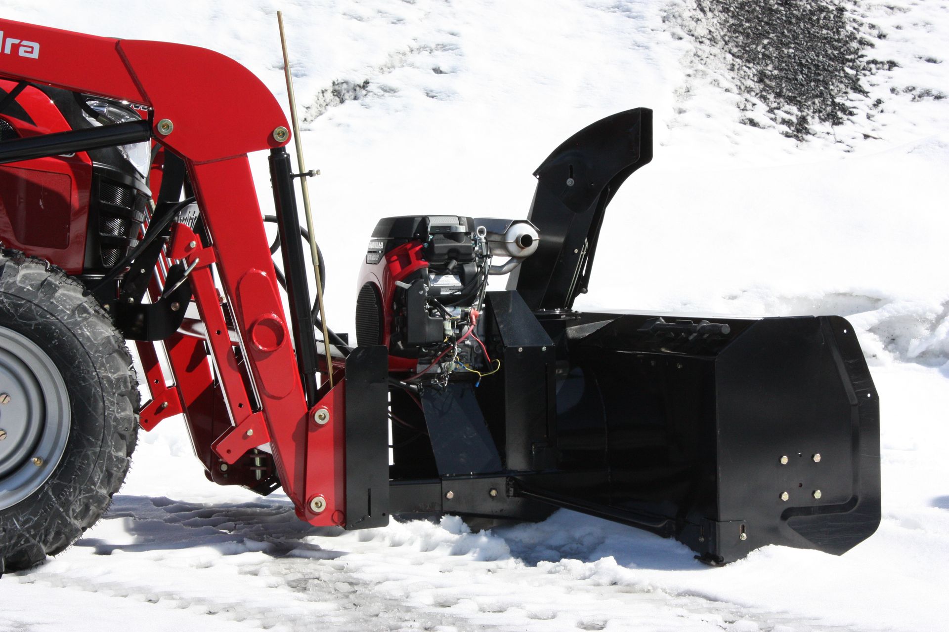 A red tractor with a snow plow 72″ VANTAGE SNOWBLOWER FOR TRACTORS EQUIPPED WITH