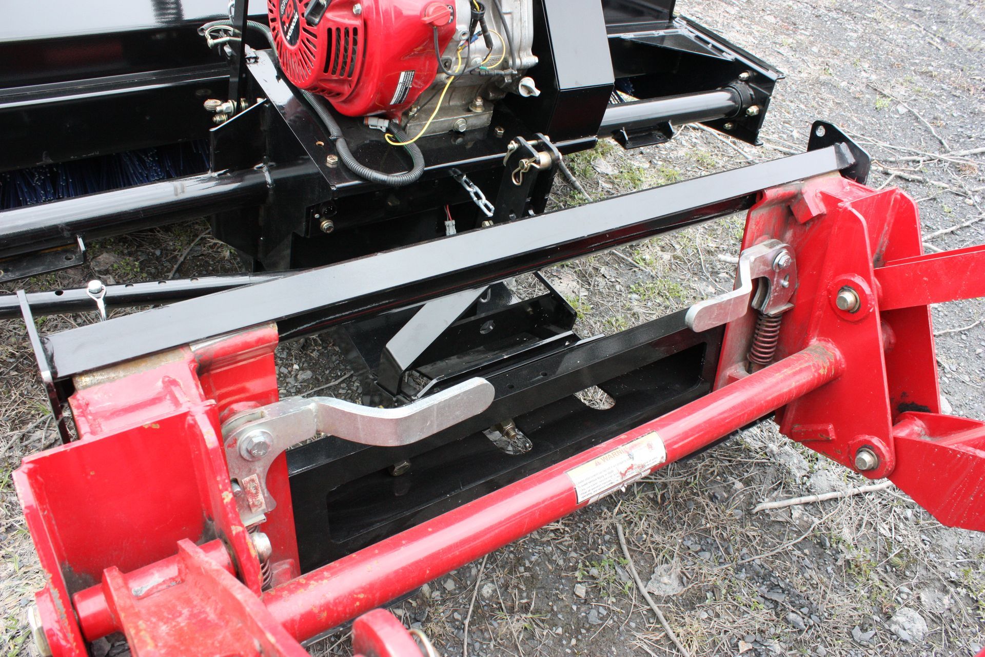 A red and black machine 72″ VANTAGE SNOWBLOWER FOR TRACTORS EQUIPPED WITH